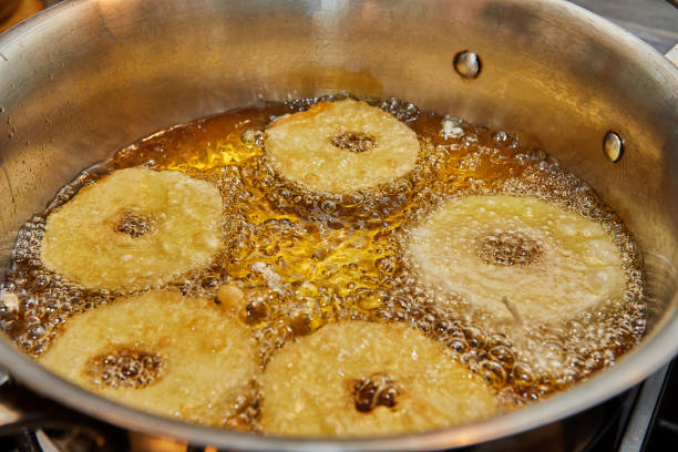 istock Cooking apple pancake. Apple donut in boiling oil 1396196859