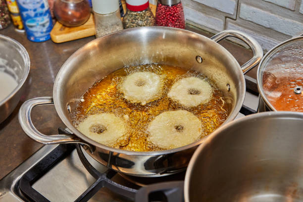 istock Cooking apple pancake. Apple donut in boiling oil 1396196980