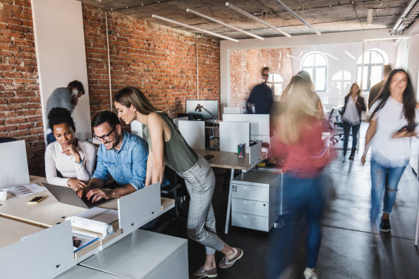 istock Working on laptop at busy corporate office! 1396197034
