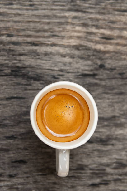 Top view of espresso cup on wooden table background with copy space