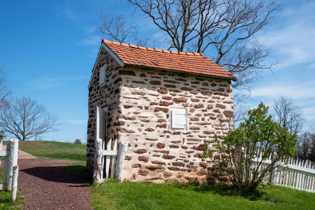 Colonial American stone smokehouse in idyllic landscape
