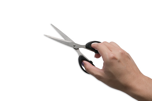 Stylish man hand holding scissors isolated on white background.