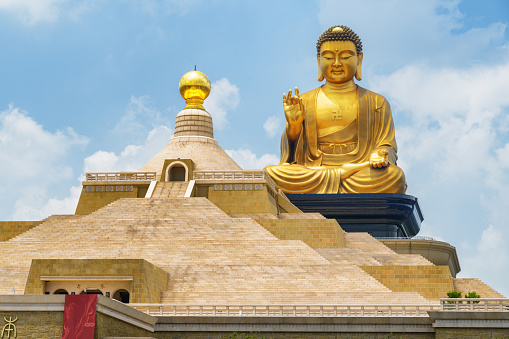 Kaohsiung, Taiwan - April 29, 2019: Amazing view of the Fo Guang Big Buddha in the Fo Guang Shan Buddha Museum on blue sky background. Taiwan is a popular tourist destination of Asia.