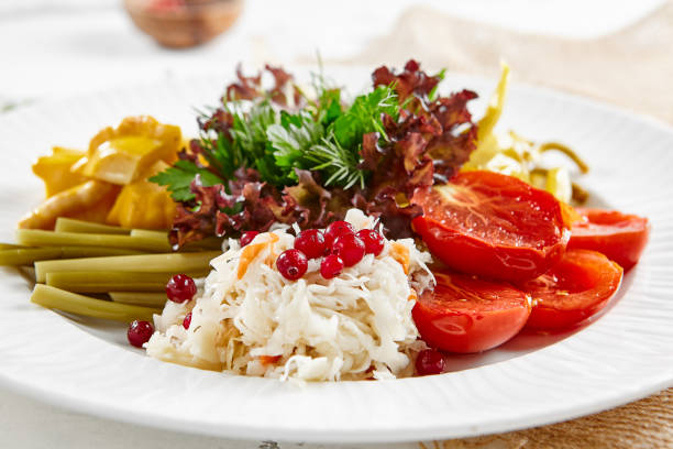 istock Appetizers from pickled vegetables in white stone background. Authentic food in restaurant menu. Mix from salted tomatoes, cucumber,  pickled pepper, sauerkraut. Assorted from marinated vegetables. 1396199897