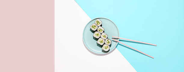 Classic japanese sushi with fresh cucumber - kappa maki. Kappa hosomaki in minimal style. Simple maki sushi with cucumber. Vegan sushi roll.