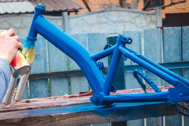 istock father paints a bicycle for a child. 1396200847