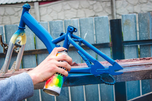 istock father paints a bicycle for a child. 1396200849
