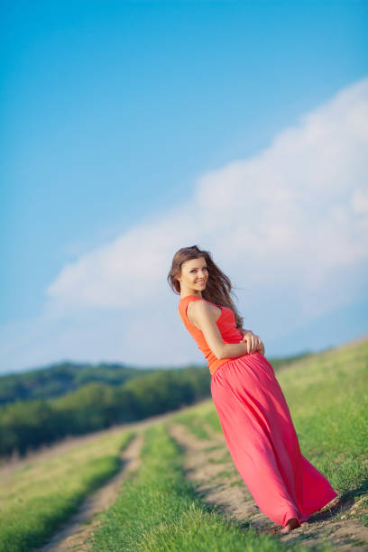 istock Relaxing beautiful woman walking alone on green grass in summer 1396201219