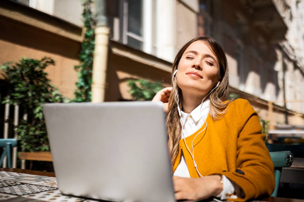 istock In outdoor cafe with laptop 1396202029