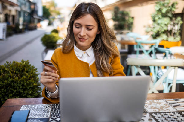 istock Woman using laptop in cafe for online shopping 1396202068