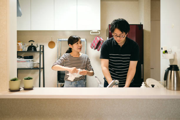istock Couple washing dishes together in domestic kitchen 1396202109