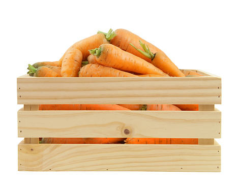 Carrot in wooden crate isolated on white background