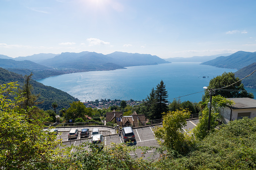 Big lake, Italy. Lake Maggiore, aerial view. View from the village of Campagnano with the town of Maccagno below. Important and famous tourist itinerary in northern Italy. The Lombard and Piedmontese coasts are visible from Luino (on the left) to Stresa (on the horizon)