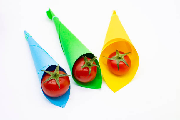 Cherry tomato in multicolored bags on a white background. Vegetables for salad