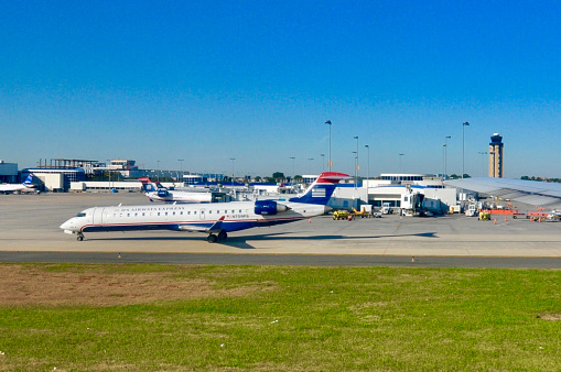 Chicago, IL, USA - June 6 2021: Morning at Terminal 3 (American Airlines) at O'Hare International Airport. American Airlines planes being prepared by ground crew for a busy day of travel.