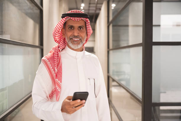 istock Cheerful Middle Eastern businessman with smart phone 1396207703