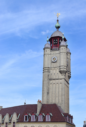 The rebuilt medieval Belfry of Bergues, in Bergues, Hauts-de-France. Destroyed in the Second world War, the 47m high tower is now UNESCO listed. Copy space to left.