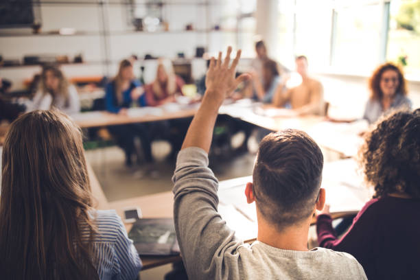 istock Back view of college student wants to ask something on a class. 1396209957