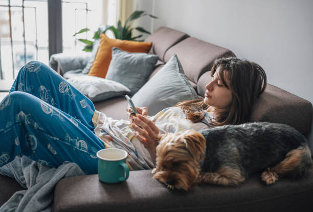 istock Young woman relaxing at home and using a technology. 1396210349