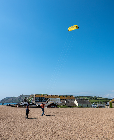 West Bay, UK. Sunday 8 May 2022. Flying a kite at West Bay in Dorset