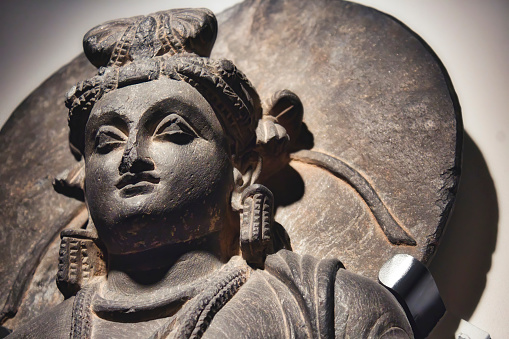 Schist rock statue of a teaching bodhisattva close-up on the face