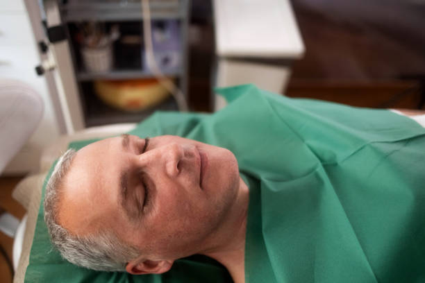 A mature man lies in an aesthetic center while resting from a facial treatment