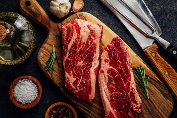 istock Pair of top blade steak on wooden cutting board 1396211344