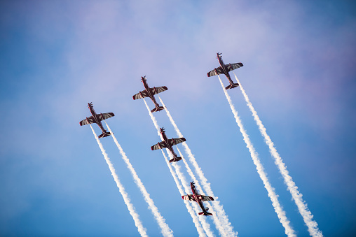 Silhouettes of seven fighter planes with smoke in airshow. Clear blue sky with copy space. Image taken with Hasselblad H3D Camera System and developed from RAW.