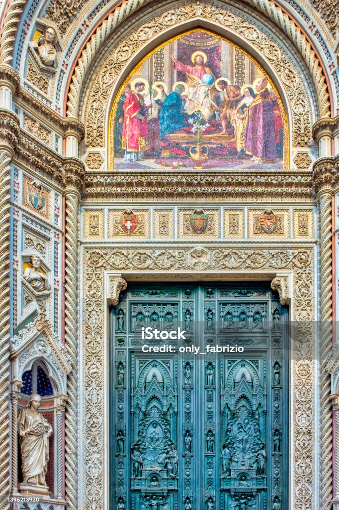 The main portal of the Duomo di Firenze The main portal of the Duomo di Firenze with the mosaic representing Christ enthroned with Mary and John the Baptist and the statue of Saint Reparata, Florence, Italy Architecture Stock Photo