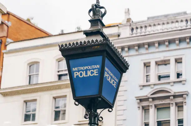 Close-up of a traditional police lantern, on display outside a police station in central London, England.