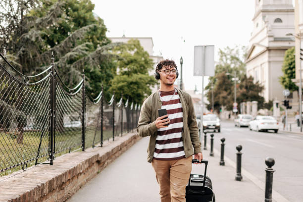 istock Good looking young man walking on city street 1396215425