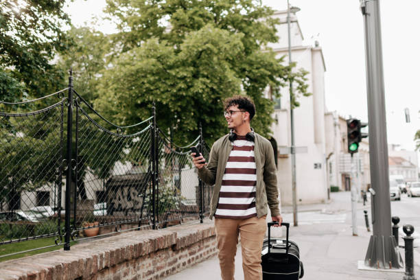istock Good looking young man walking on city street 1396215428