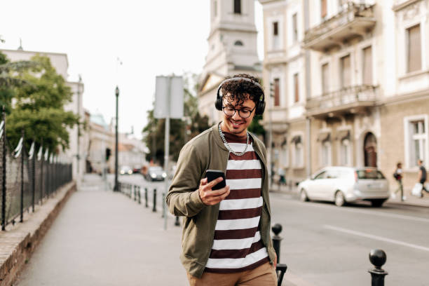 istock Good looking young man walking on city street 1396215432