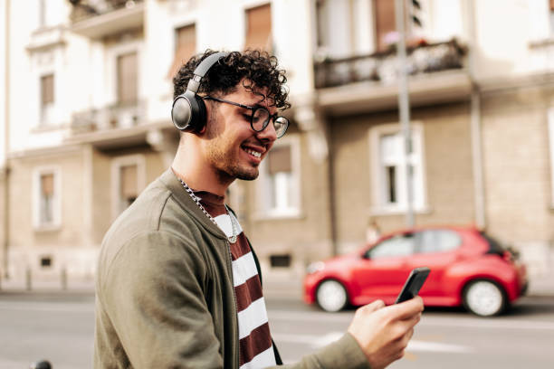 istock Good looking young man walking on city street 1396215500