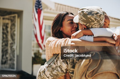 istock American soldier saying farewell to his family at home 1396215534