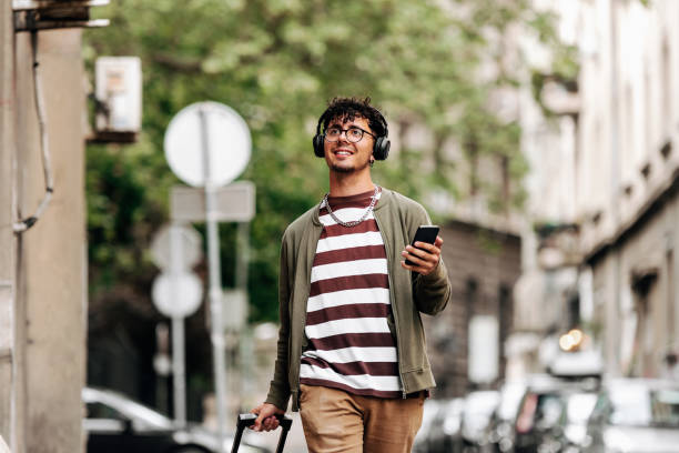 istock Good looking young man walks down the street 1396215596