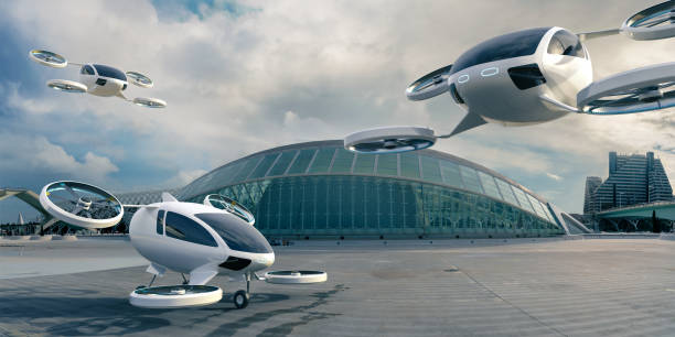 Three eVTOL Aircraft Parked and In Mid Flight In Front Of Terminal Building A fleet of generic white electric powered Vertical Take Off and Landing eVTOL aircraft with four rotors. One aircraft is parked with landing gear on empty concrete surface in front of glass terminal building on an overcast day. Two other eVTOL's are in mid flight in the background and foreground. propeller photos stock pictures, royalty-free photos & images