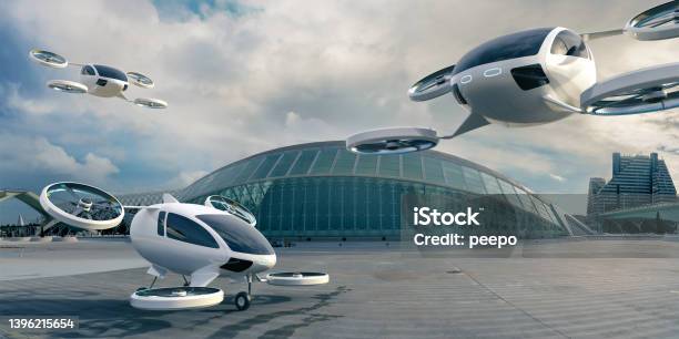 Three Evtol Aircraft Parked And In Mid Flight In Front Of Terminal Building Stock Photo - Download Image Now