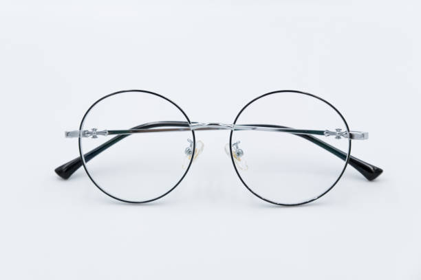 istock Selective focus round eyeglasses with silver rim. Isolated white background. 1396216378