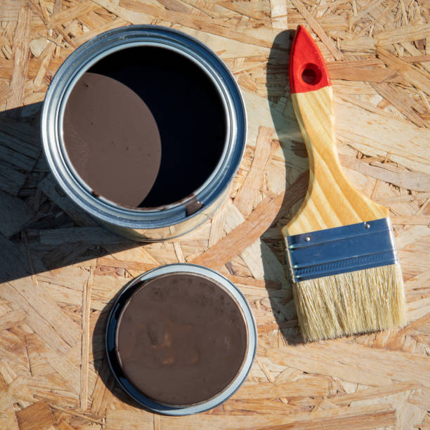 istock Paintbrush and paint on chipboard, preparing for repair 1396216477