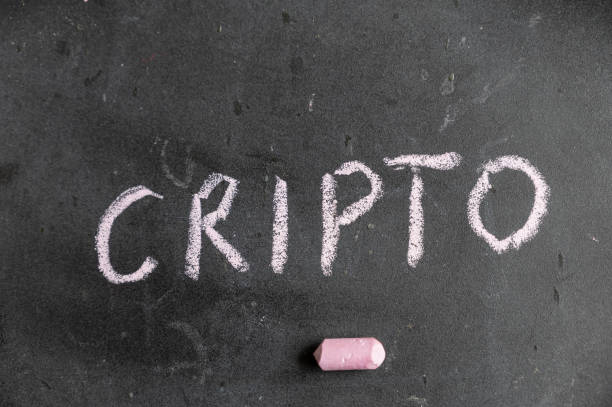 istock Crypto. A word written in pink chalk on a black chalkboard. Handwritten text. 1396217001