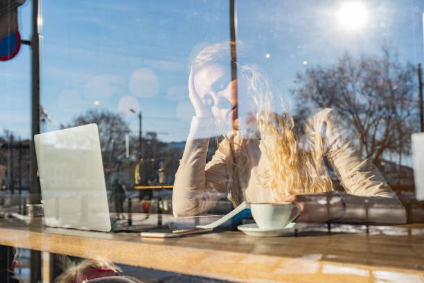 istock Tired female student studying in coffee shop 1396217675