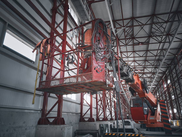istock Basket of telehandler inside of hangar 1396217788