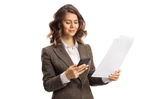 Young woman with a mobile phone and a paper document isolated on white background