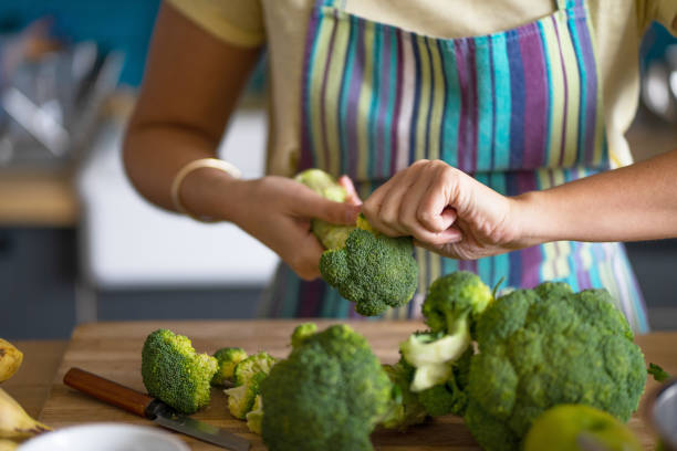 istock Young woman preparing broccoli for lunch 1396219652