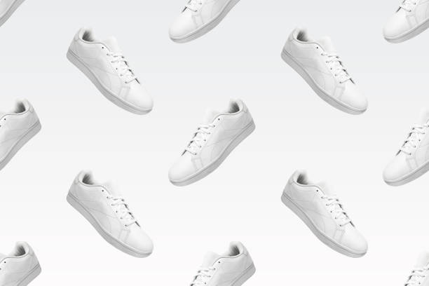 istock Pattern of white sneakers isolated on white background. 1396220265