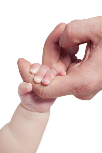 Father holding a little newborn baby's hand isolated on white background