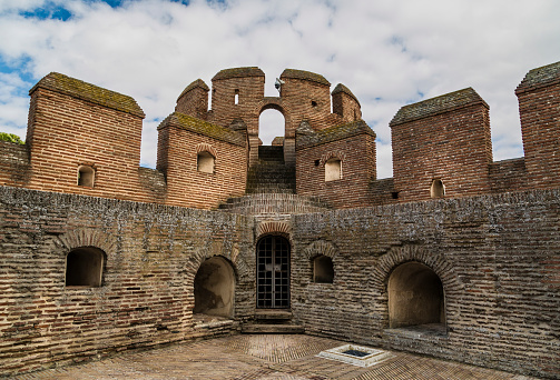 Part of historical Byzantine castle In Istanbul. The historical Byzantine wall is towards the white sky.