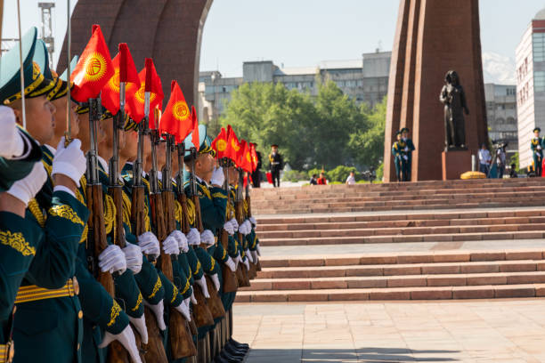 Guard of honor with Kyrgyzstan flags on weapons during Victory Day on a square Bishkek, Kyrgyzstan - May 9, 2022: Guard of honor with Kyrgyzstan flags on weapons during Victory Day on a square bishkek stock pictures, royalty-free photos & images