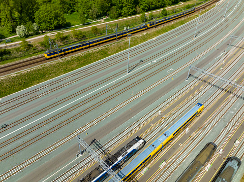 Railroad yard in Zwolle at the Engelse Werk park seen from above during a beautiful summer day. Trains are stationary at the yard for various lines in Overijssel.
